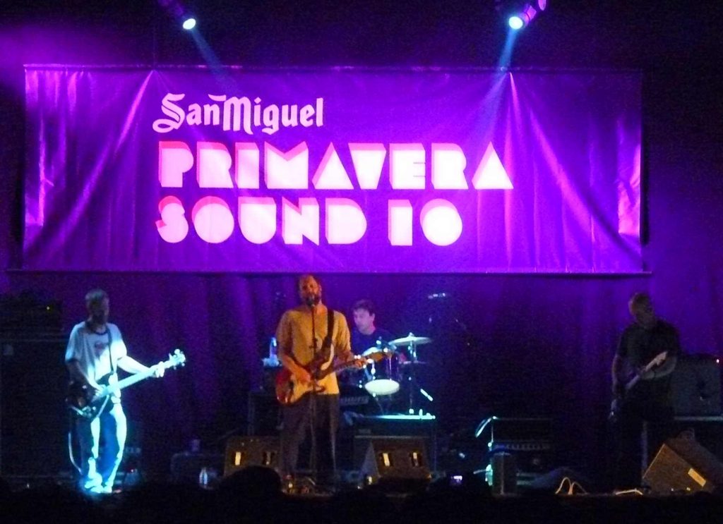 Photo of the band Built to Spill performing live at Primavera Sound 2010, with the festival's logo in the background. [Alt text by ALT Text Artist GPT]