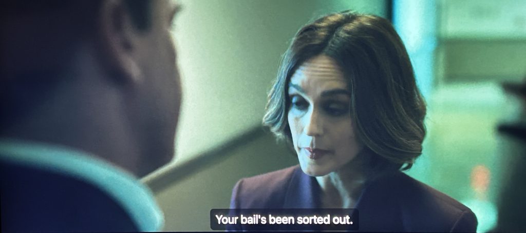 Screen capture from Your Friends & Neighbors season 1 episode 8. Kat Resnick, Andrew βCoopβ Cooperβs lawyer, portrayed by Heather Lind, speaks to him in a courthouse hallway. Close-up of her face with a composed, serious expression, wearing a dark blazer. Subtitle reads βYour bailβs been sorted out.β
Alt text by ALT Text Artist GPT